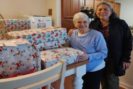 Elder Orphan Care client with gifts and volunteer who delivered them